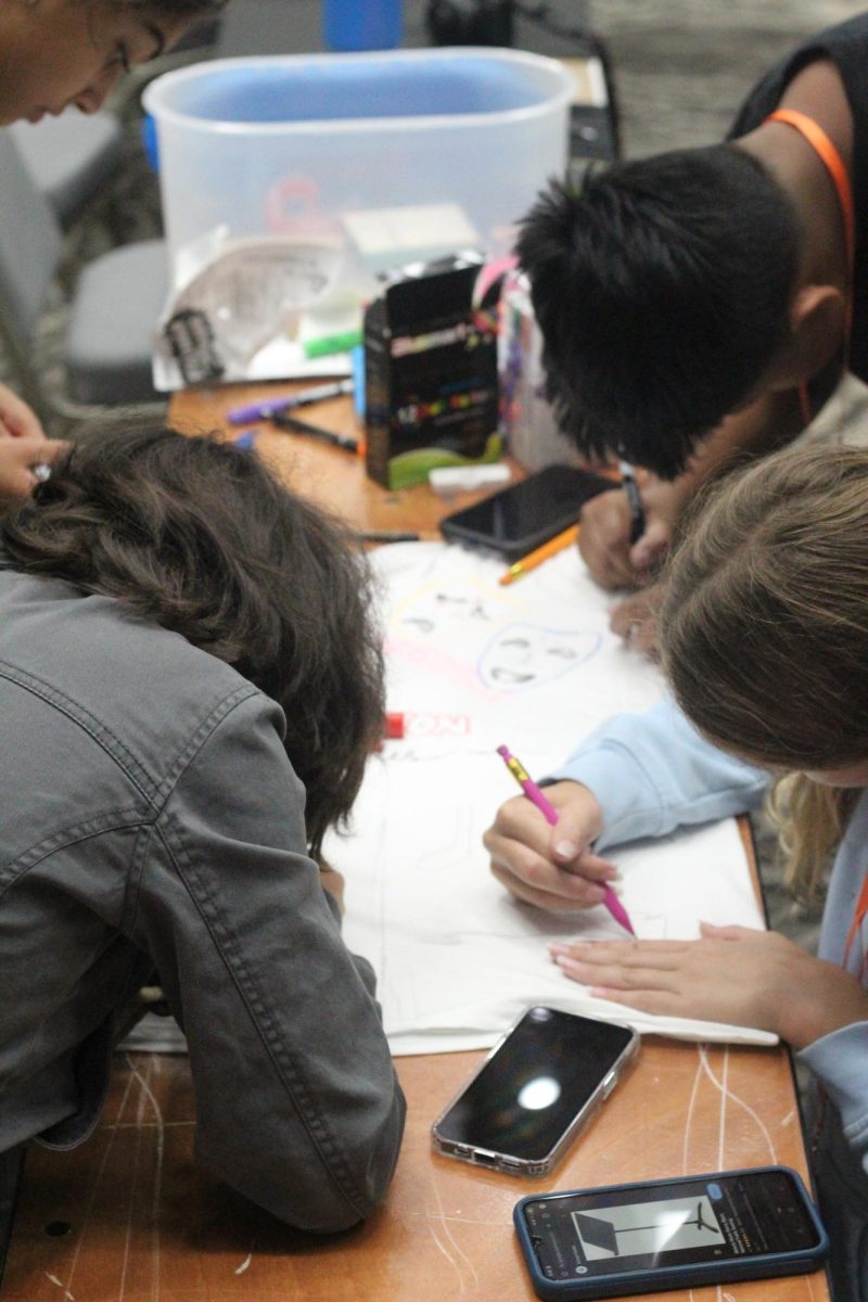 Lawton Chiles Middle School students use reference images to get accurate details on their shirt in order to showcase what makes their school special. 